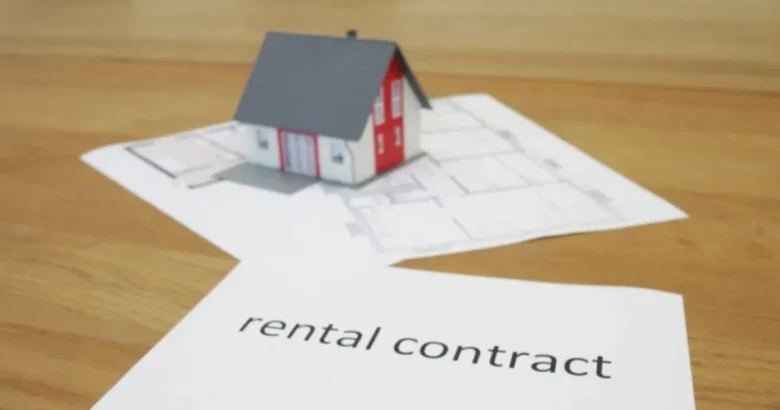 家の模型と「rental contract」と書かれた書類